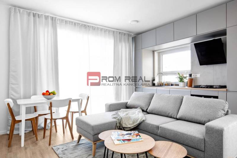 Living room with a kitchen in a 3-room apartment, light sofa and dining table.