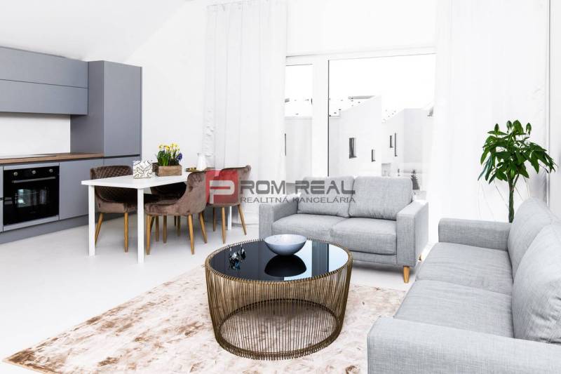 Bright living room with a kitchenette, dining table, and sofa in a 3-room apartment.