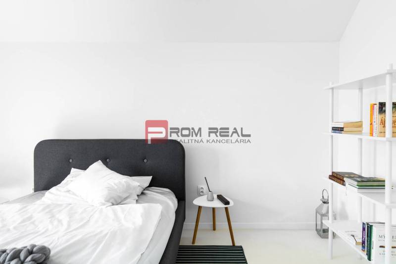 Bedroom with a bed and a bookshelf in a 3-room apartment.