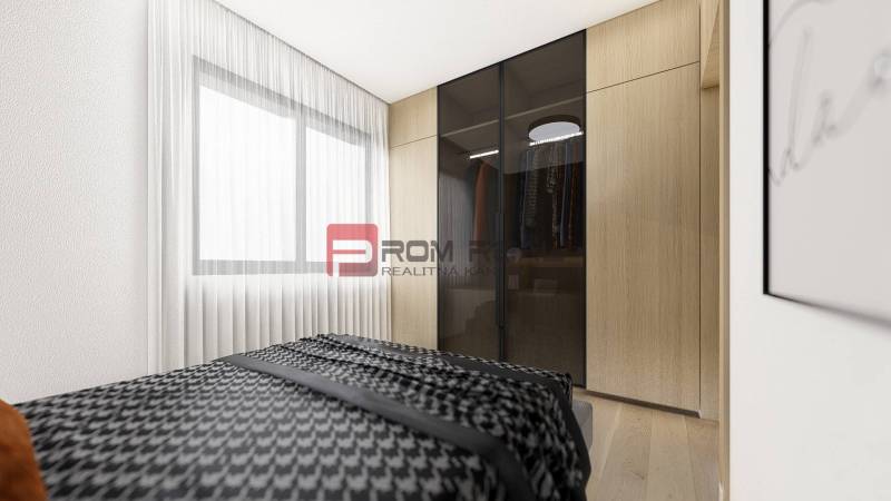 Bedroom in a 2-room apartment with a cabinet and a large window, light curtains.