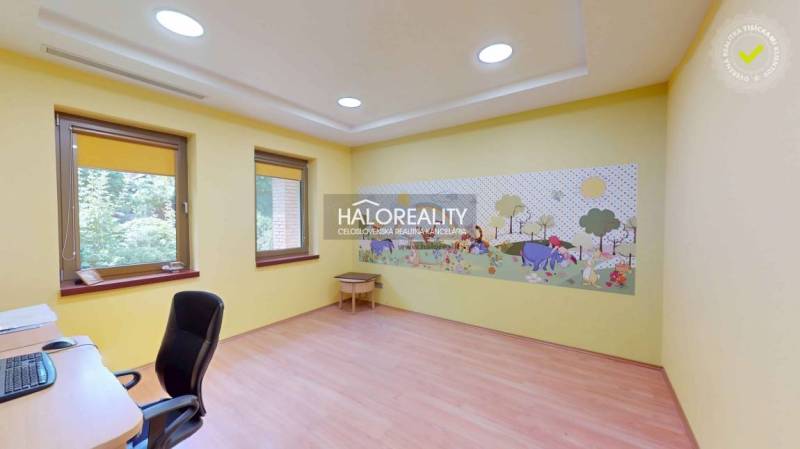 Children's room with a mural in a family house, light yellow wall color.