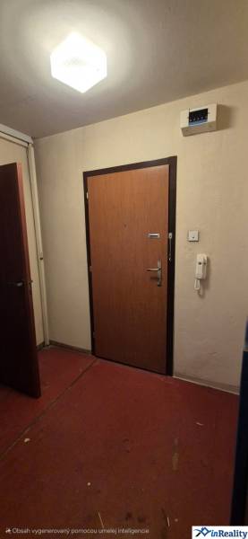 Entrance door to a 3-room apartment with red linoleum and white walls.