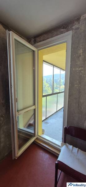 A glazed balcony with a sofa in a 3-room apartment.