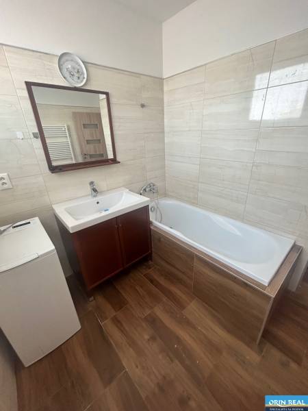 Bathroom in a 3-room apartment with a bathtub, sink, and washing machine.