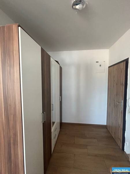 A hallway with a wardrobe and wooden doors in a 3-room apartment.
