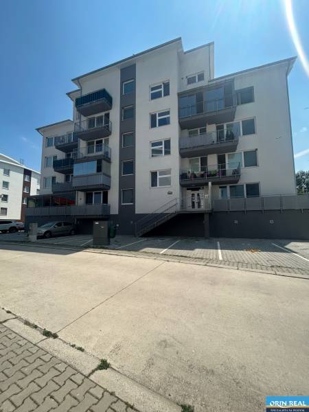 Five-story apartment building with a staircase and parking lot on Slavomírova Street in Slovenský Grob.
