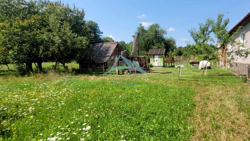 A country house surrounded by greenery with a dirt road on A.H. Škultétyho Street.