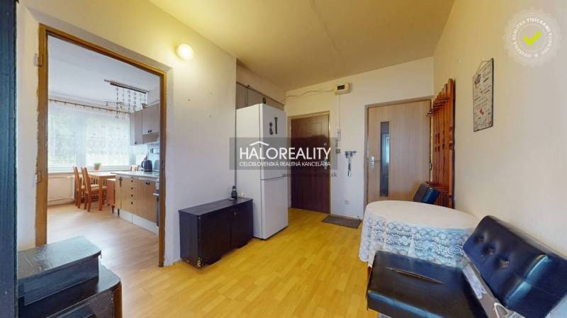 Interior of a 4-room apartment, kitchen with dining area, hallway with refrigerator.