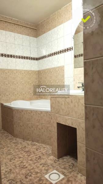 Bathroom in a 4-room apartment with a corner bathtub and ceramic tiles.