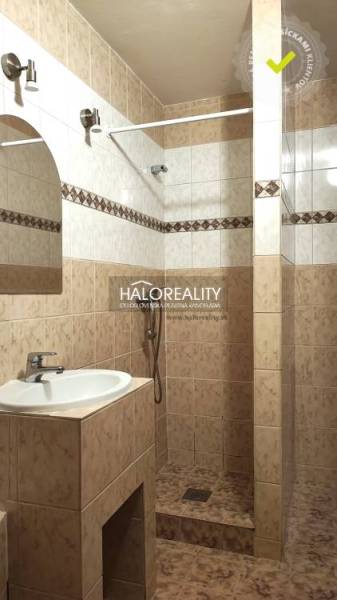Bathroom with a shower and a sink, suitable for a 4-room apartment.