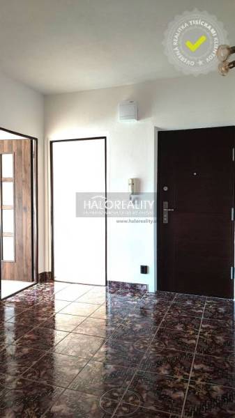 The entrance hall of a 4-room apartment with dark tiles and white walls.