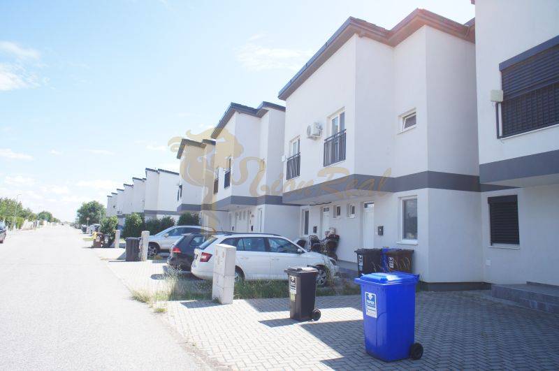 Row houses on Platanova Street in Miloslavov with parking spaces in front of the houses.