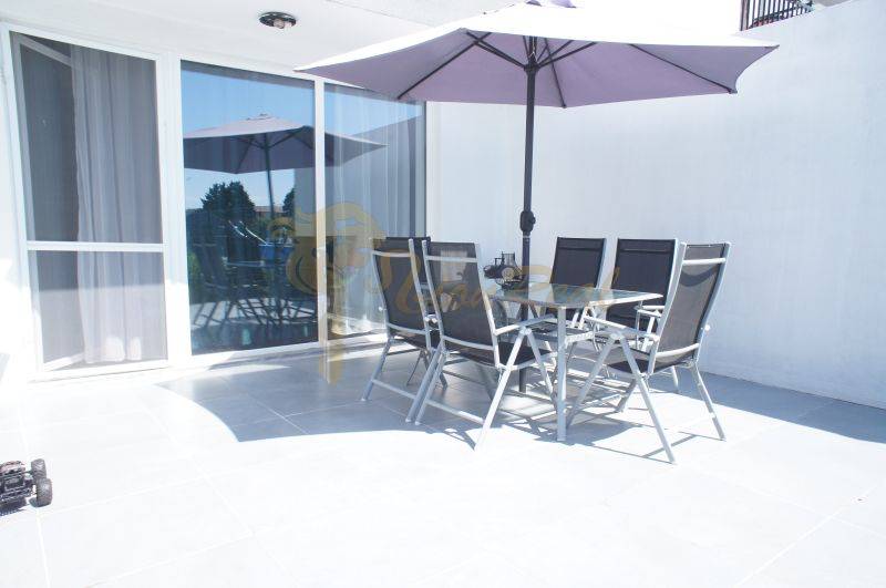 A terrace with seating and a parasol in a family house on Platanova Street in Miloslavov.
