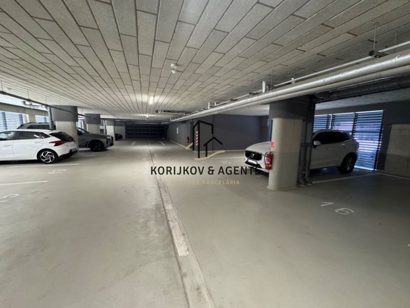 Underground garage with multiple parking spaces and parked cars in Košice.