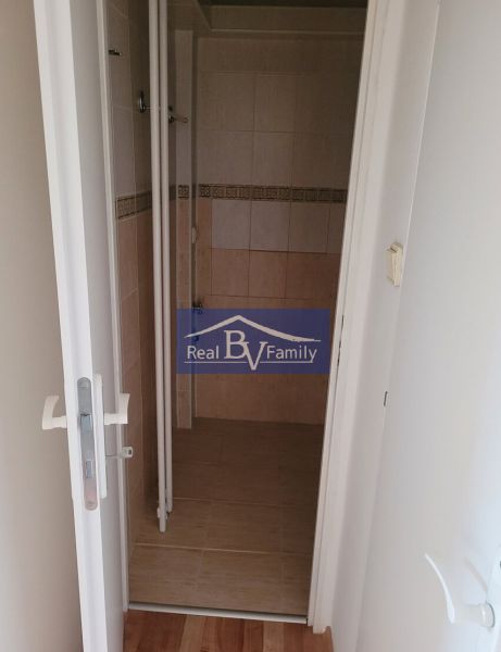A bathroom in a 3-room apartment with tiles and wall tiles featuring a subtle pattern.