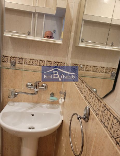 A bathroom with a sink, mirror, and details in a 3-room apartment.