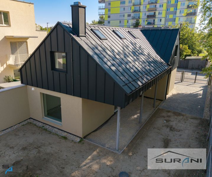 A family house on Železničná Street in Bratislava - Ružinov with a metal roof and a yard.