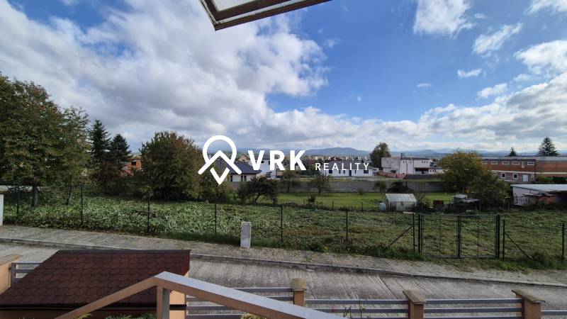 View from a family house in Ličartovce with nature and a road.