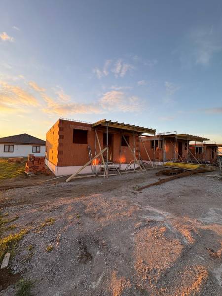 Construction of houses in Ľubotice at sunset, cladding with brick blocks.