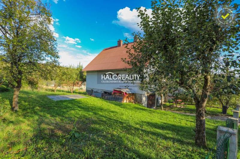 A family house in Papradno with a large garden and fruit trees, surrounded by nature.