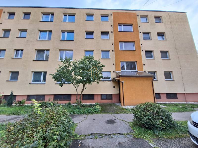 A four-story apartment building surrounded by greenery in Martin, offering 3-bedroom apartments.