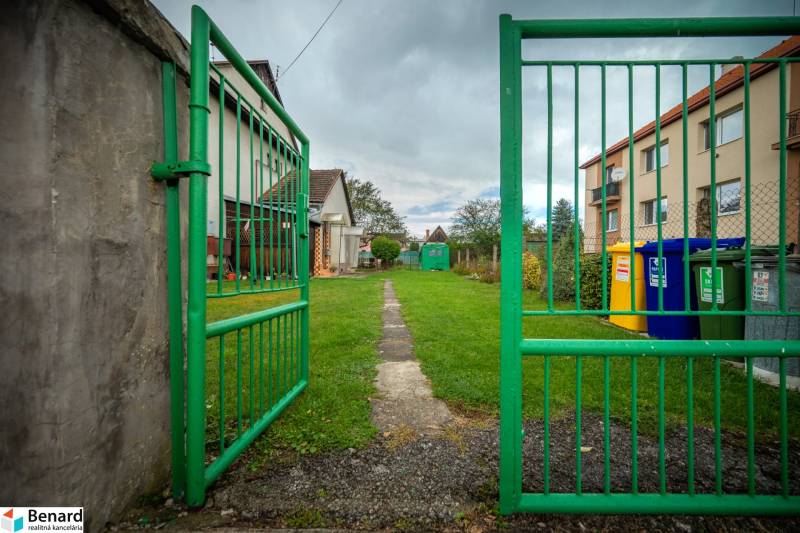 The green gate leads to the lawn near Matica Slovenská in the town of Veľký Šariš.