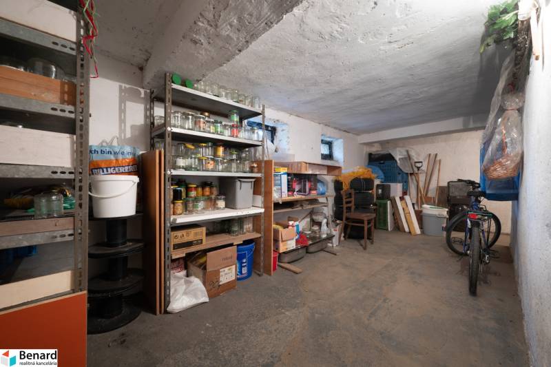 A storage space with jars and a bicycle in the basement of a 3-room apartment.