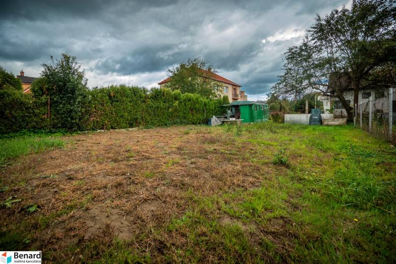 The garden on Matice Slovenskej Street in Veľký Šariš surrounded by greenery and buildings.