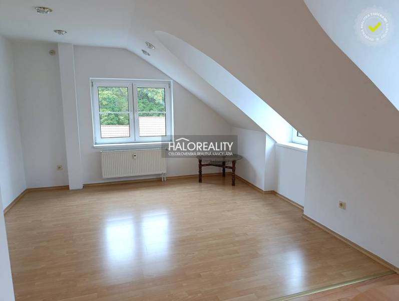 An attic room with a wooden decor floor in a 2-room apartment.