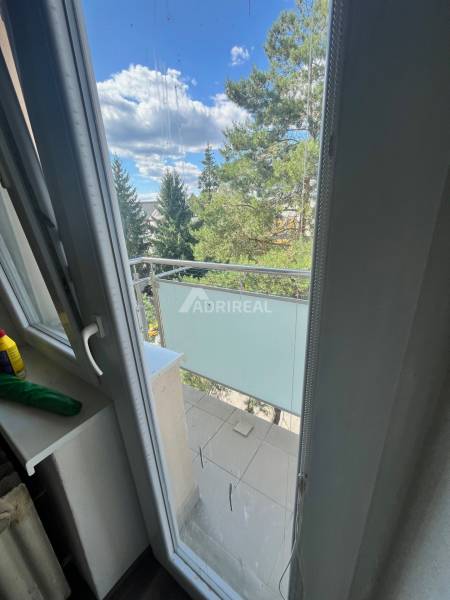 View from the balcony in a 3-room apartment with a wooden decor floor.