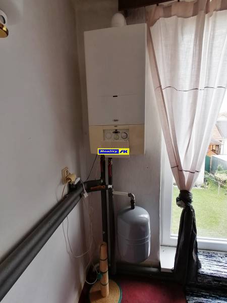 Heating in a 3-room apartment with curtains and a garden view.