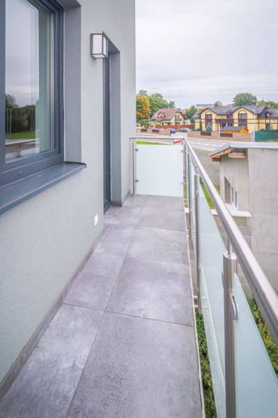 A balcony with tiles in a 2-room apartment with a view of Kukučínova Street in Poprad.