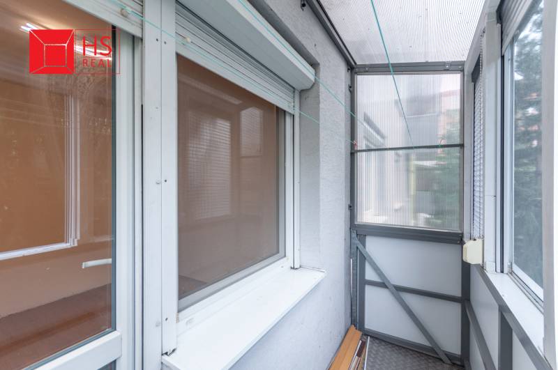 A balcony with glazing in a 3-room apartment, suitable for relaxation and drying laundry.