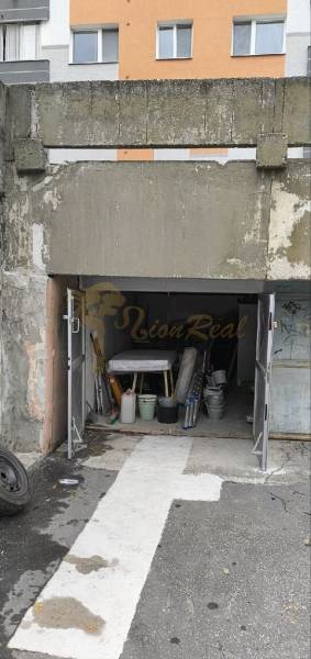 Garages on Dudvážska Street in Bratislava - Podunajské Biskupice with an open gate and various items.