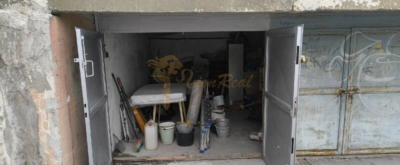 An open garage on Dudvážska Street in Bratislava - Podunajské Biskupice, full of tools and materials.