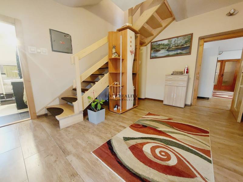 Wooden staircase, carpet, wood-patterned floor, and decor in a family house.