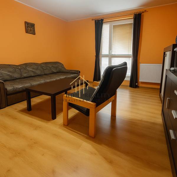 Living room in a family house with orange walls and a wooden decor floor.