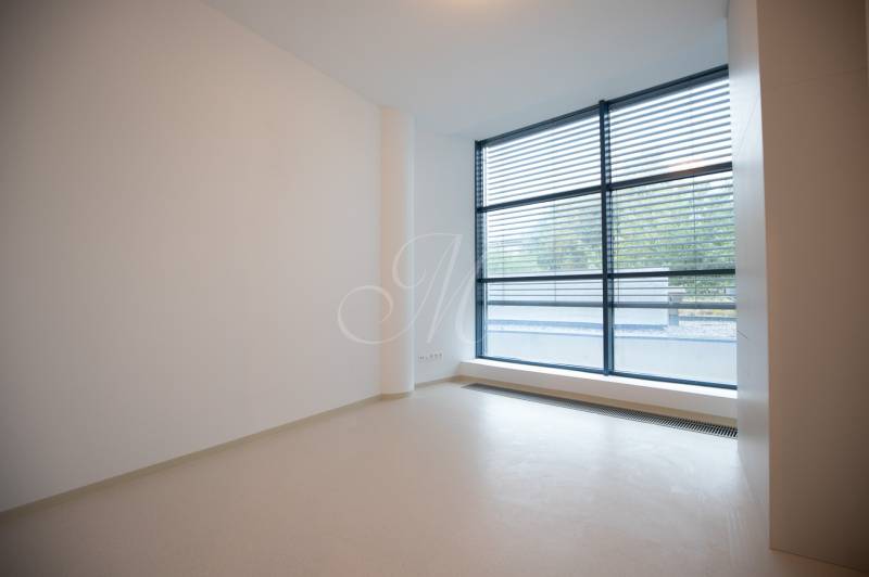 A spacious room with a large window and blinds in a 4-room apartment.