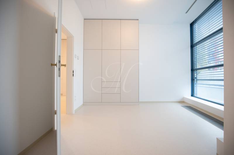 A bright room with a large window and a built-in wardrobe in a 4-room apartment.