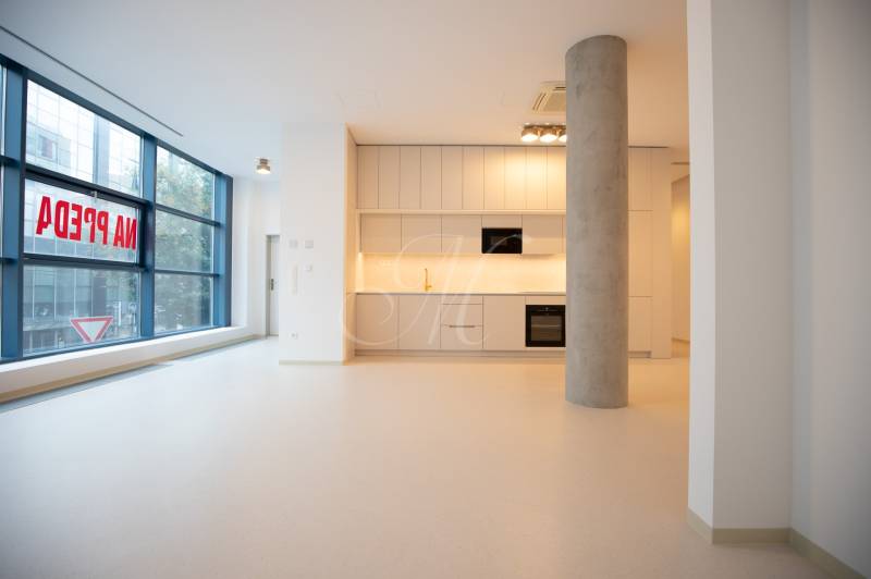 Interior of a 4-room apartment with a spacious kitchen and large windows.