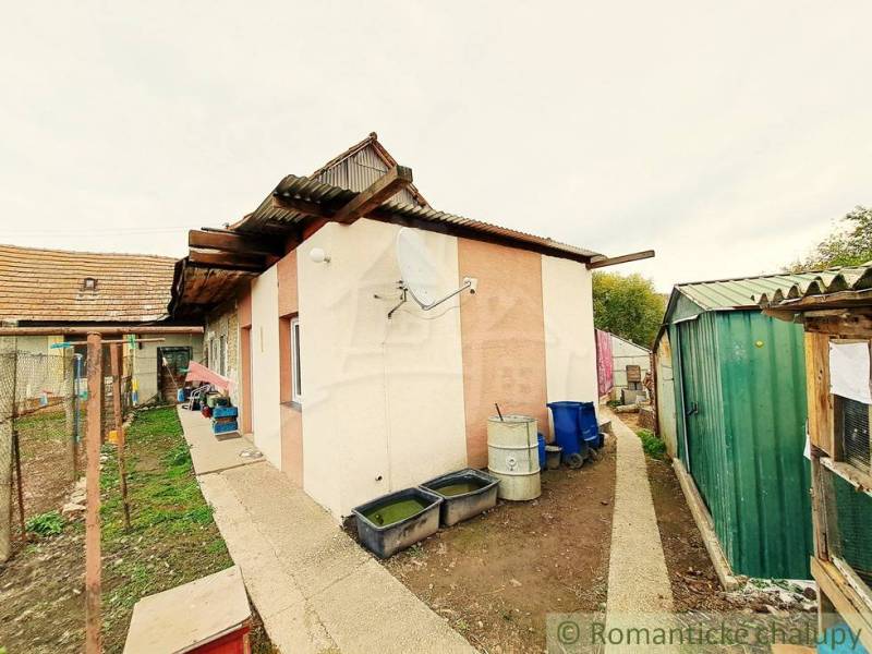 The courtyard of a family house in Ľudovítová with a shelter and outdoor equipment.