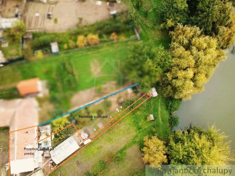 Aerial view of a waterfront property with nature in Ľudovítová.