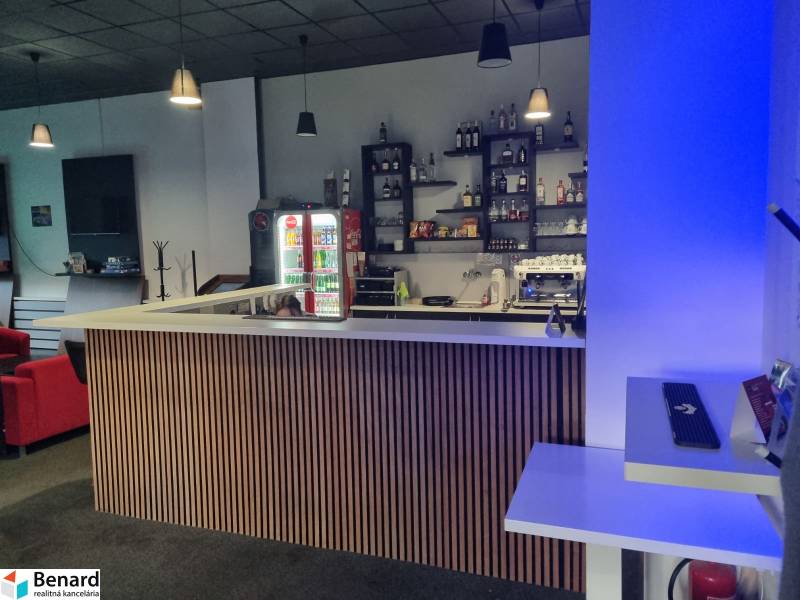 Modern commercial spaces with a bar counter, a vending machine, and comfortable seating.