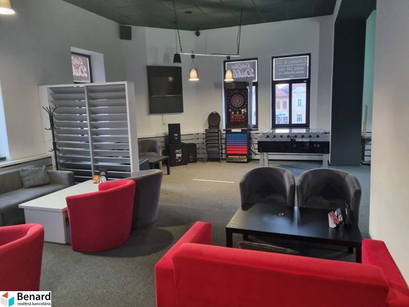 Interior of commercial premises with seating, table football, and darts.