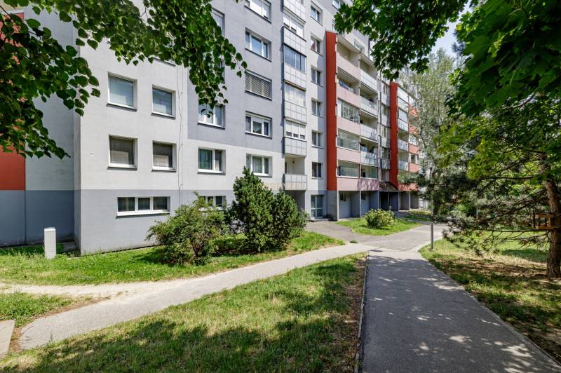 A panel apartment building surrounded by greenery on Pribišova Street in Bratislava - Karlova Ves.