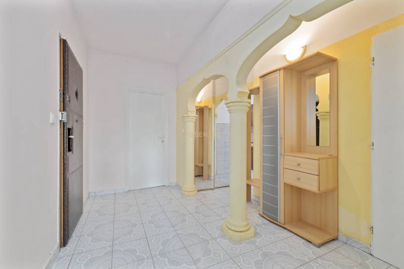 Entrance hall with arches, a mirror, and a built-in wardrobe in a 3-room apartment.