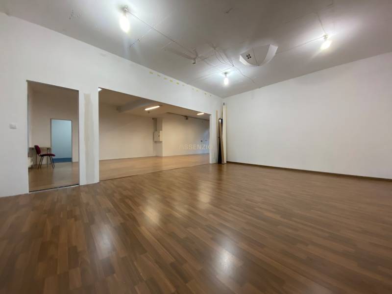 Commercial space with wood-patterned flooring and simple lighting.