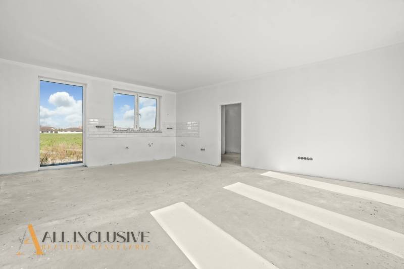The interior of a family house with white walls and large windows. Ready for completion.