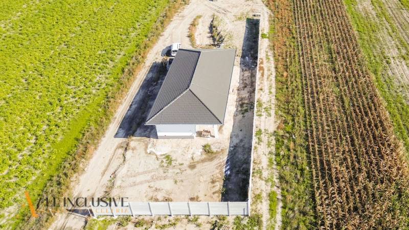 Aerial view of a family house in Gabčíkovo surrounded by fields and a road.