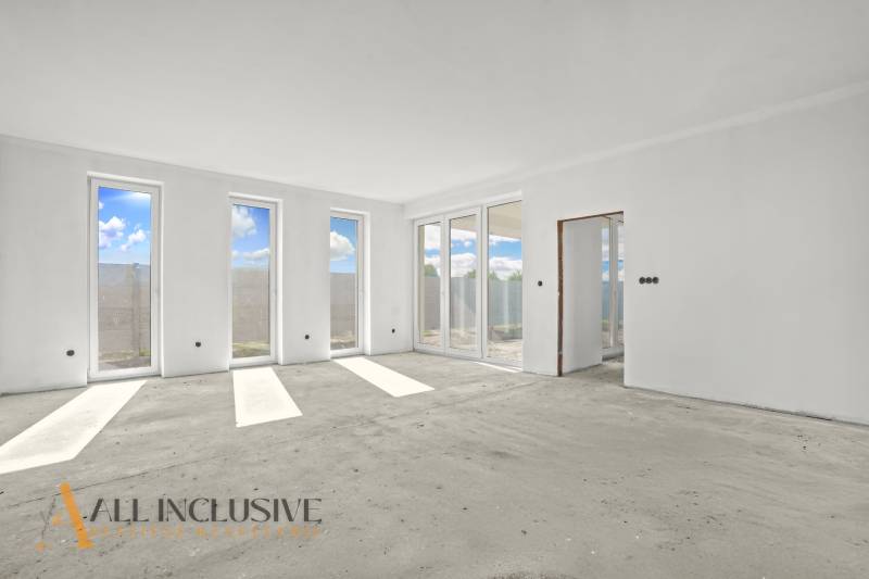 A bright spacious room in a family house with large windows and a view.